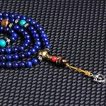 Ppxstar protection necklace tiger eye beads knot detail macro | people ​planet  x star