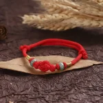 Ppxstar red string protection bracelet jade beads closeup | people ​planet  x star