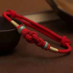 Ppxstar red string protection bracelet jade knot front | people ​planet  x star