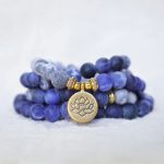 Ppxstar energy bracelet blue beads om charm closeup | people ​planet  x star