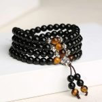 Ppxstar black obsidian bracelet tiger eye beads side angle | people ​planet  x star