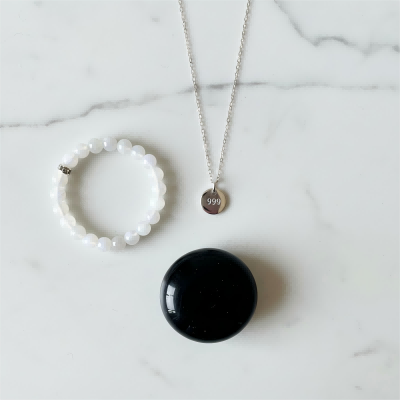 A collection of spiritual jewelry including a 999 angel number necklace and bracelets with crystals for new beginnings