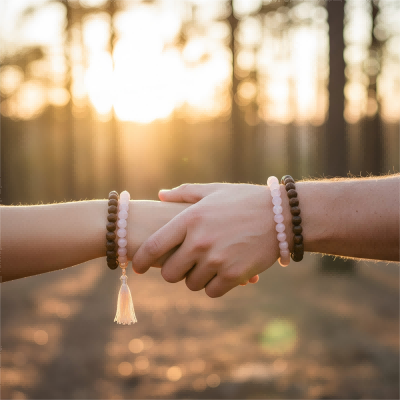 Couple holding hands wearing custom rose quartz spiritual bracelets for 919 love manifestation