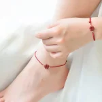 Ppxstar red rope string bracelet closeup knot detail | people ​planet  x star
