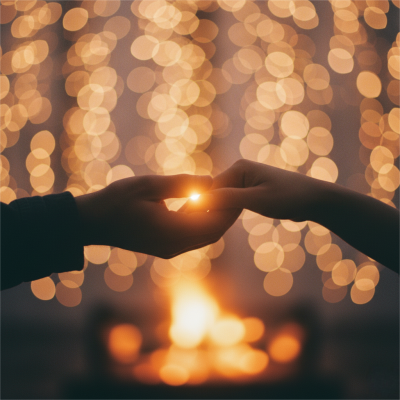 Two hands holding symbolizing the meaning of 333 in love and the connection between twin flames